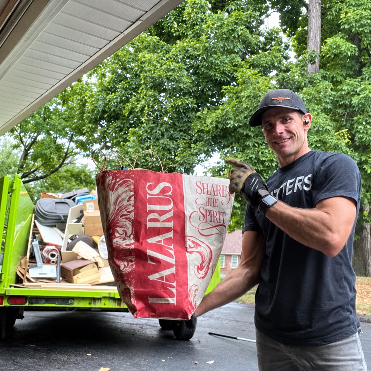 Lazarus of Sears Trash Cleanup loading items beside his green trailer